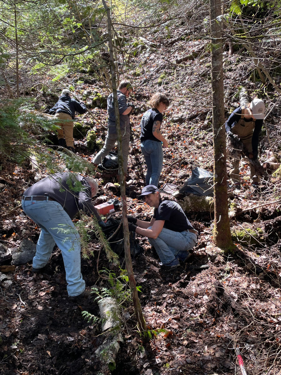 Volunteers cleanup woods during KORC cleanup event.