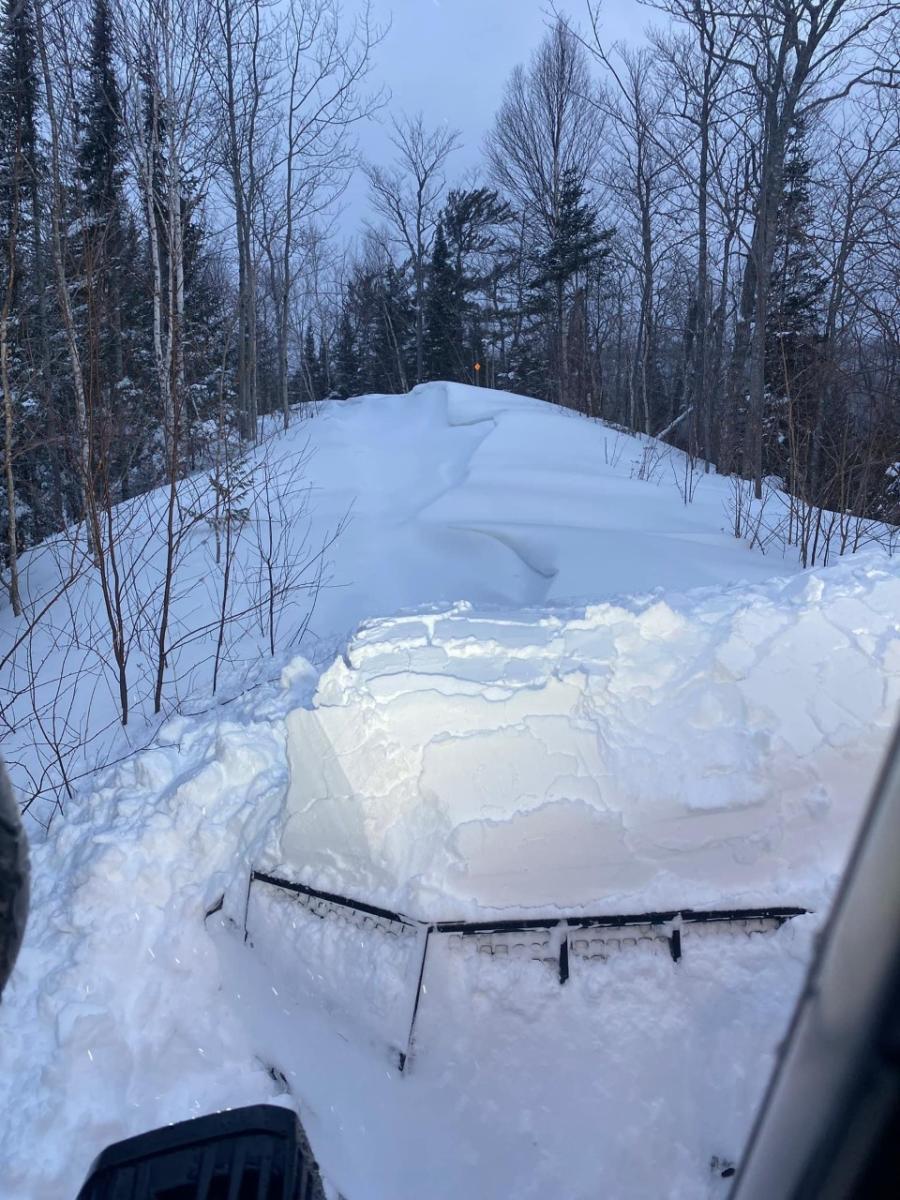 Groomer clears huge snowdrifts from trails.