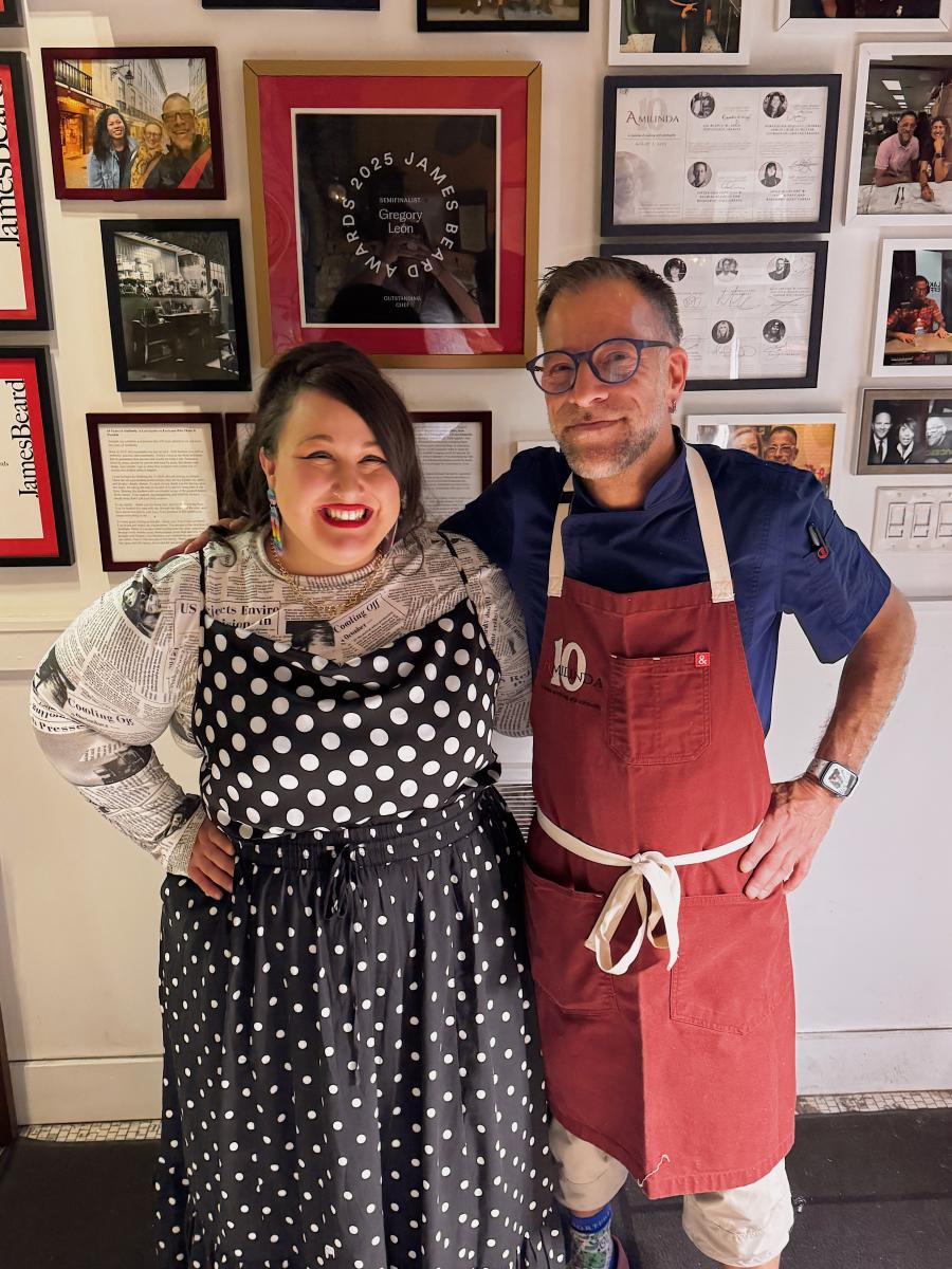 Alysse Delasandro poses with chef Gregory León beneath his 2025 James Beard Awards semifinalist plaque at Amilinda in Milwaukee.
