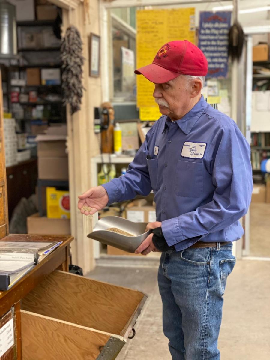 Owner Jim Gill measures grass seed