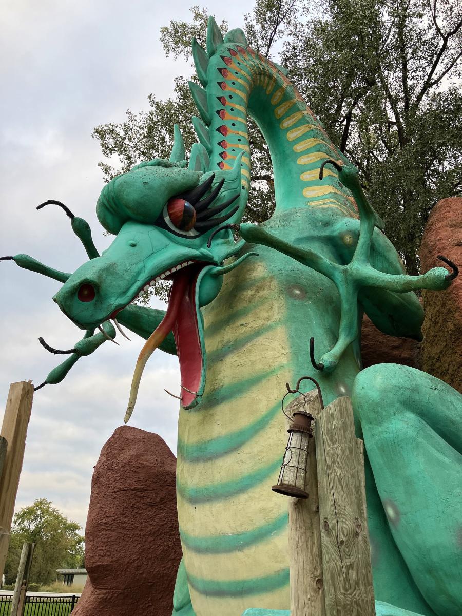 A green dragon statue looks down