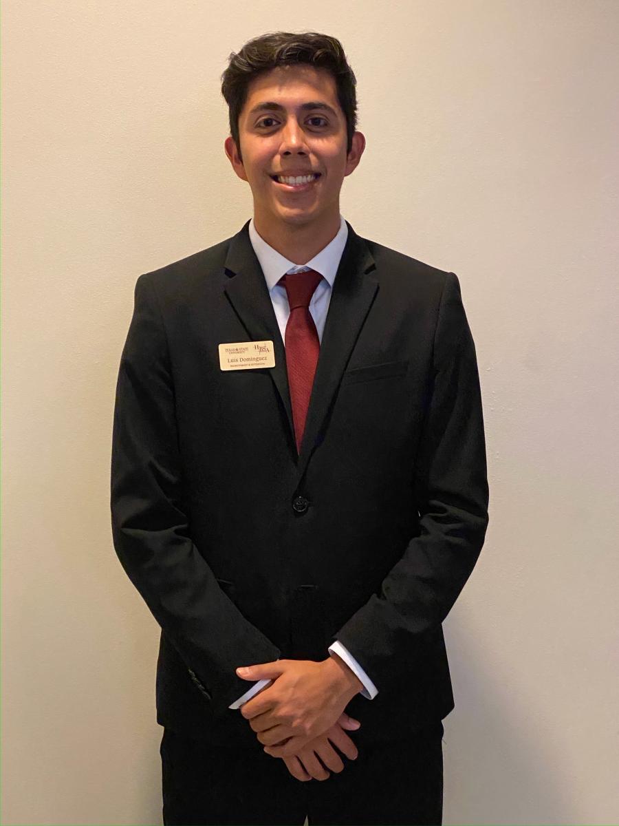 Luis Dominguez poses in his business best while a student at Texas State University in San Marcos, Texas.