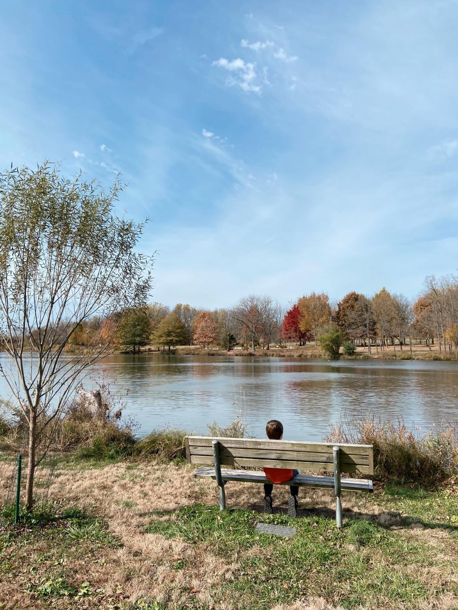 Child sitting on bench at Nathanael Greene Park