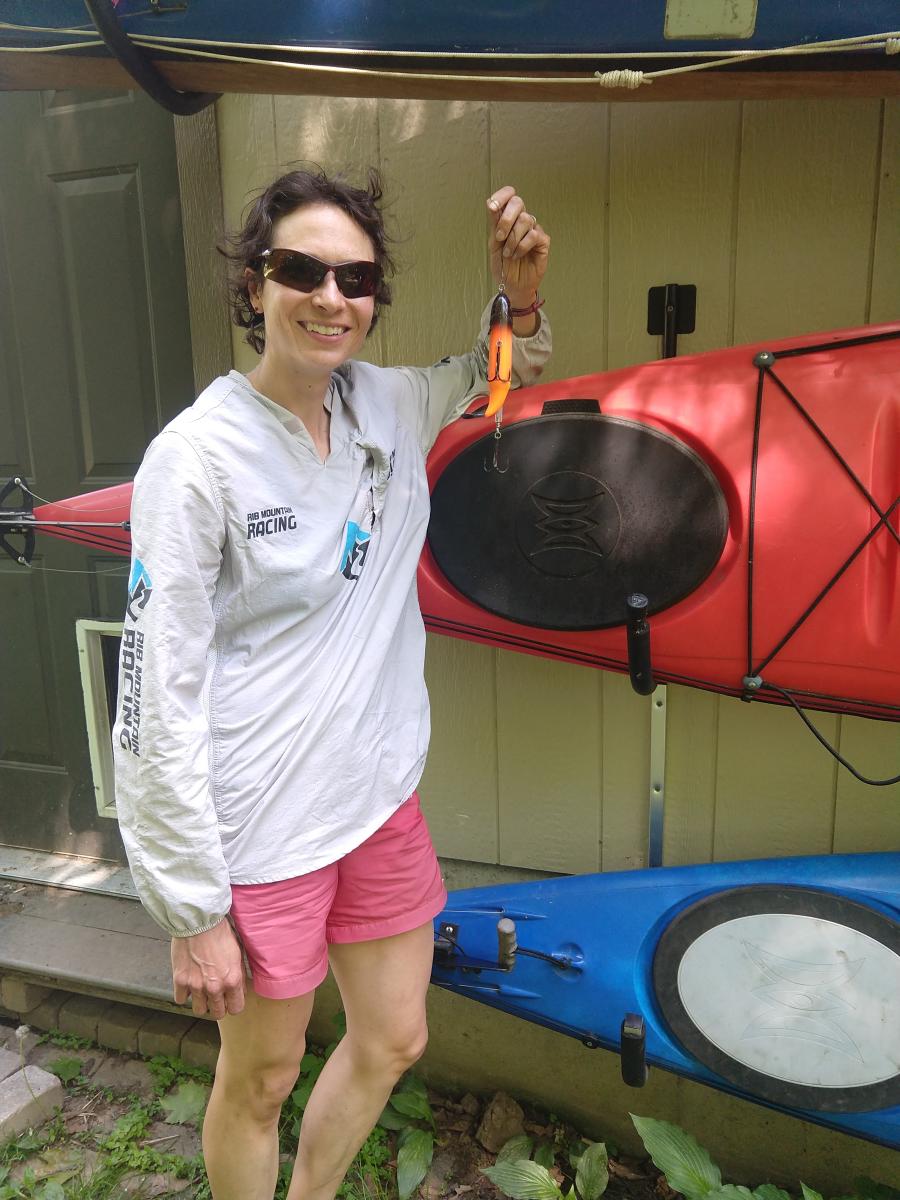 Woman next to kayaks