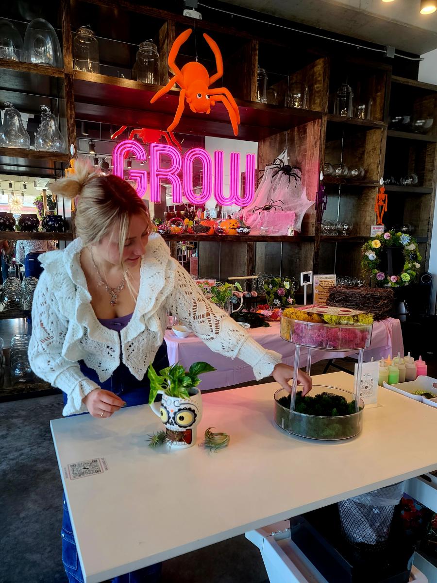 A woman makes a terrarium at GROW Giesen Plan Shop