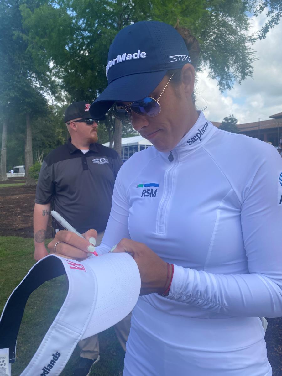 Golfer signing hat at LPGA The Chevron Championship