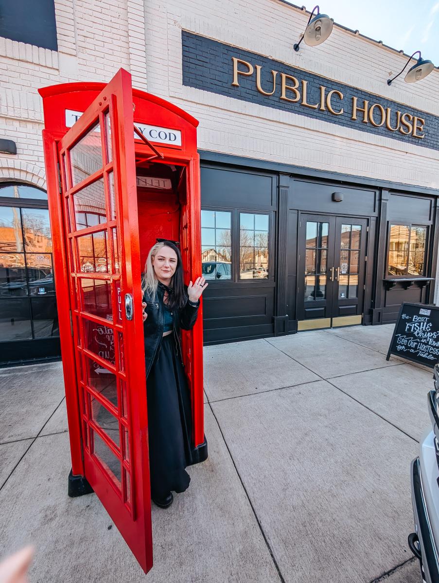 Phoenyx checking out the red phone booth at the Salty Cod in Athens, AL.