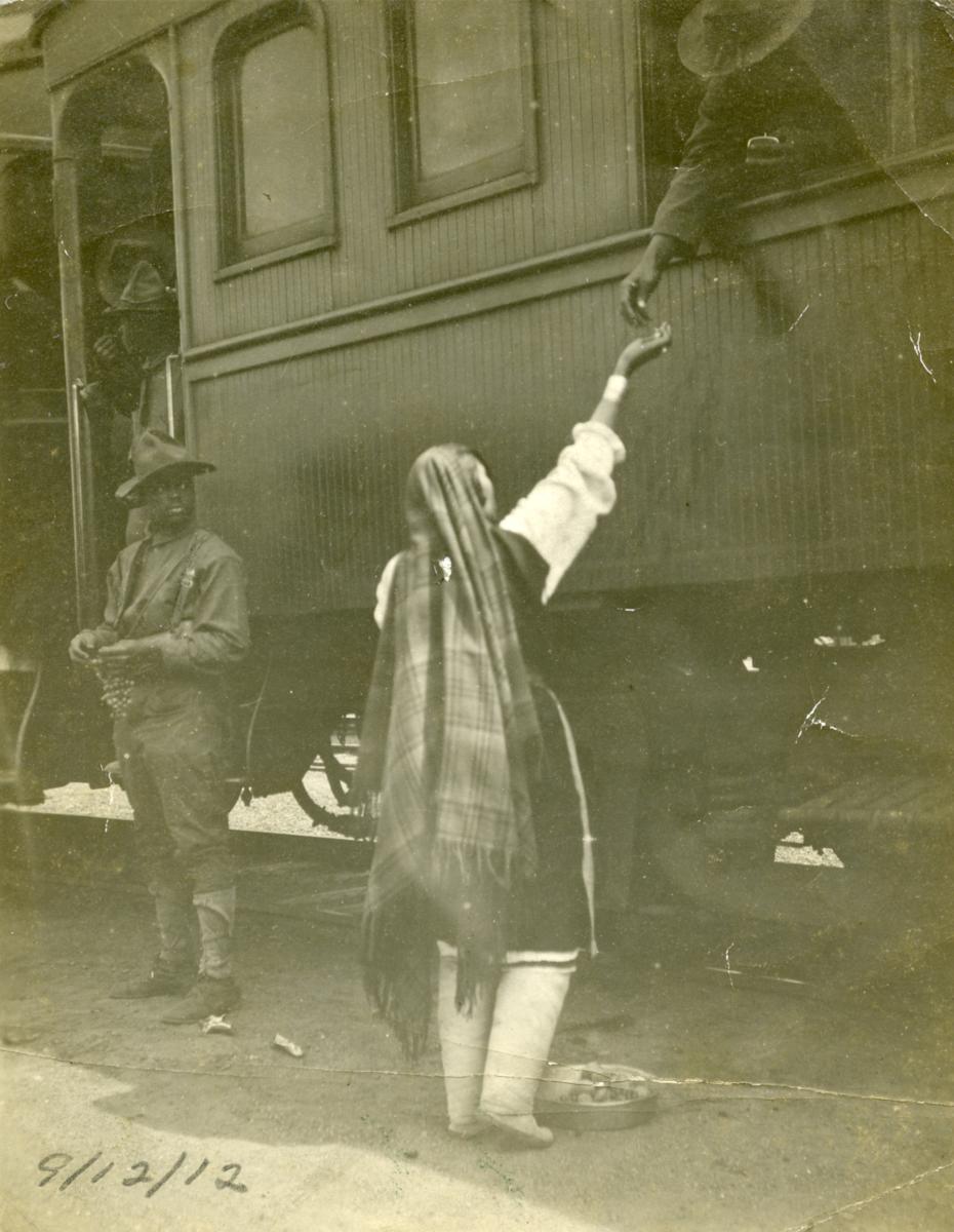 An Isleta Pueblo woman sells fruit to a soldier on a passenger train, 1912, New Mexico Magazine