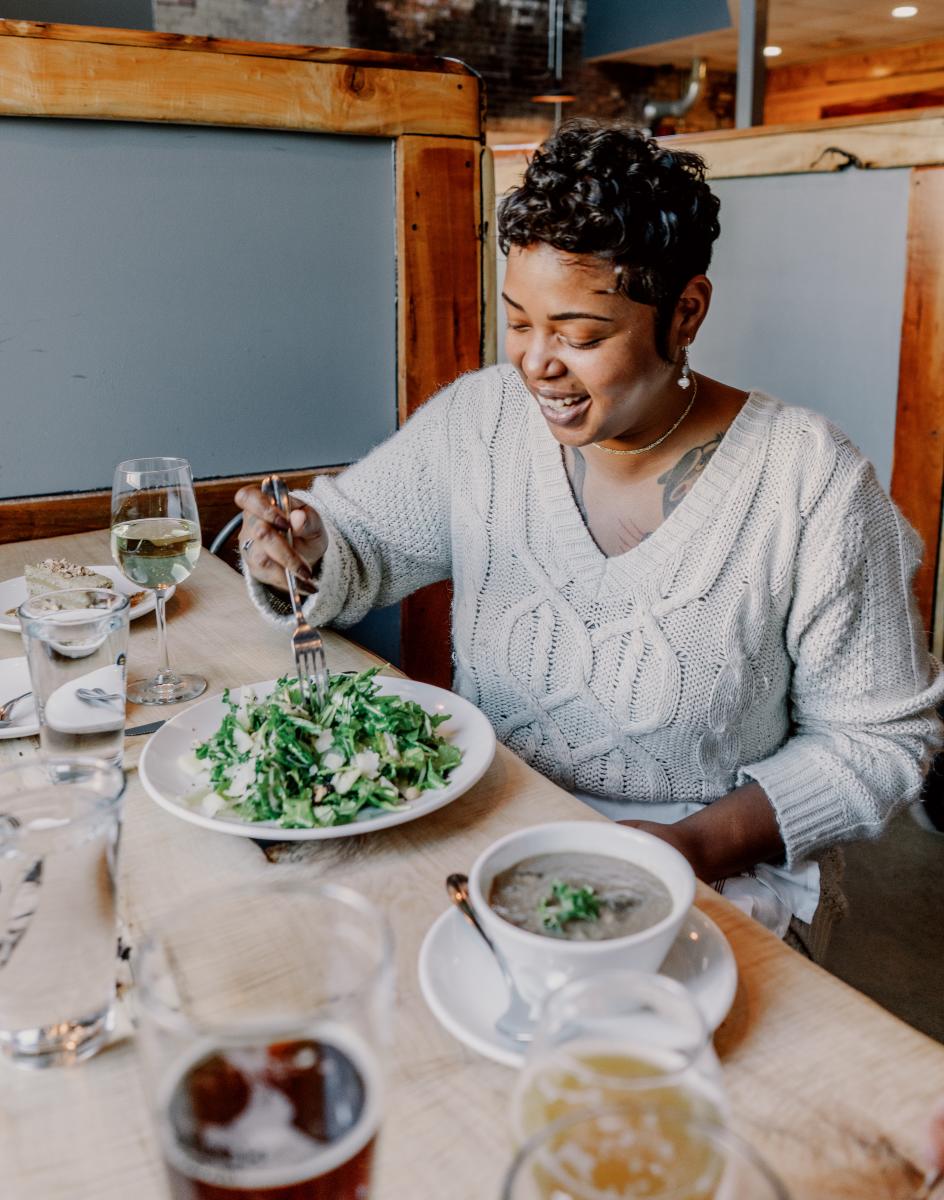 Woman eating at Junk Ditch Brewing Company