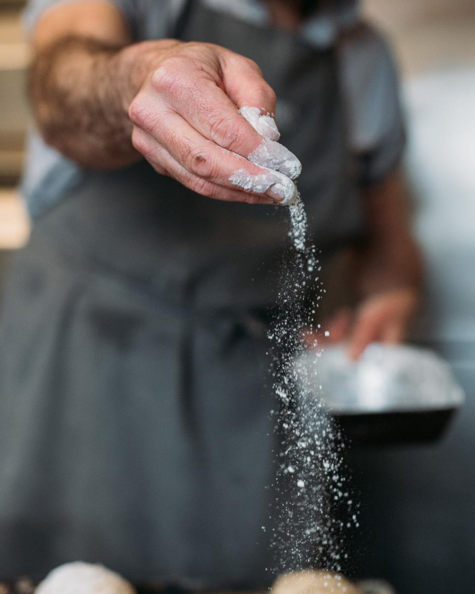 Pouring flour over the bread