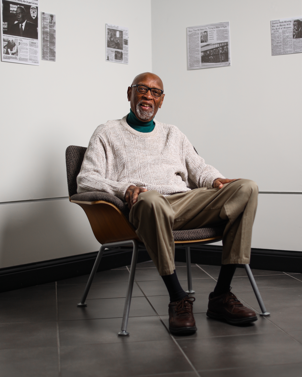 Dr. Gayln Vesey poses for a photo while sitting in a chair