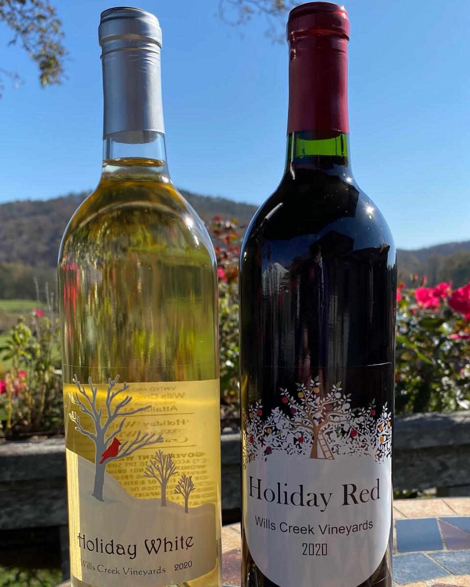 Two bottles of wine - one white wine, one red wine - marked with labels from Wills Creek Vineyards