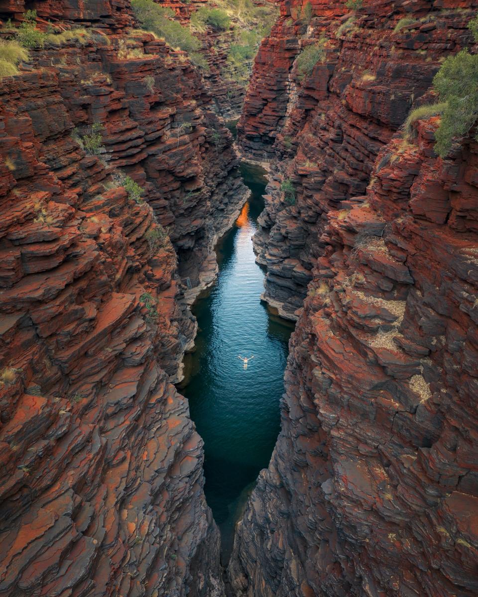 Person swimming in the waters of Joffre Gorge, Karijini National Park. Photo taken from above.