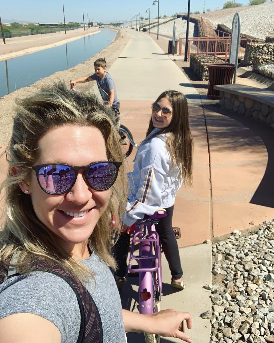  A family takes a break for a photo op while out biking along the Paseo Trail in Chandler, AZ