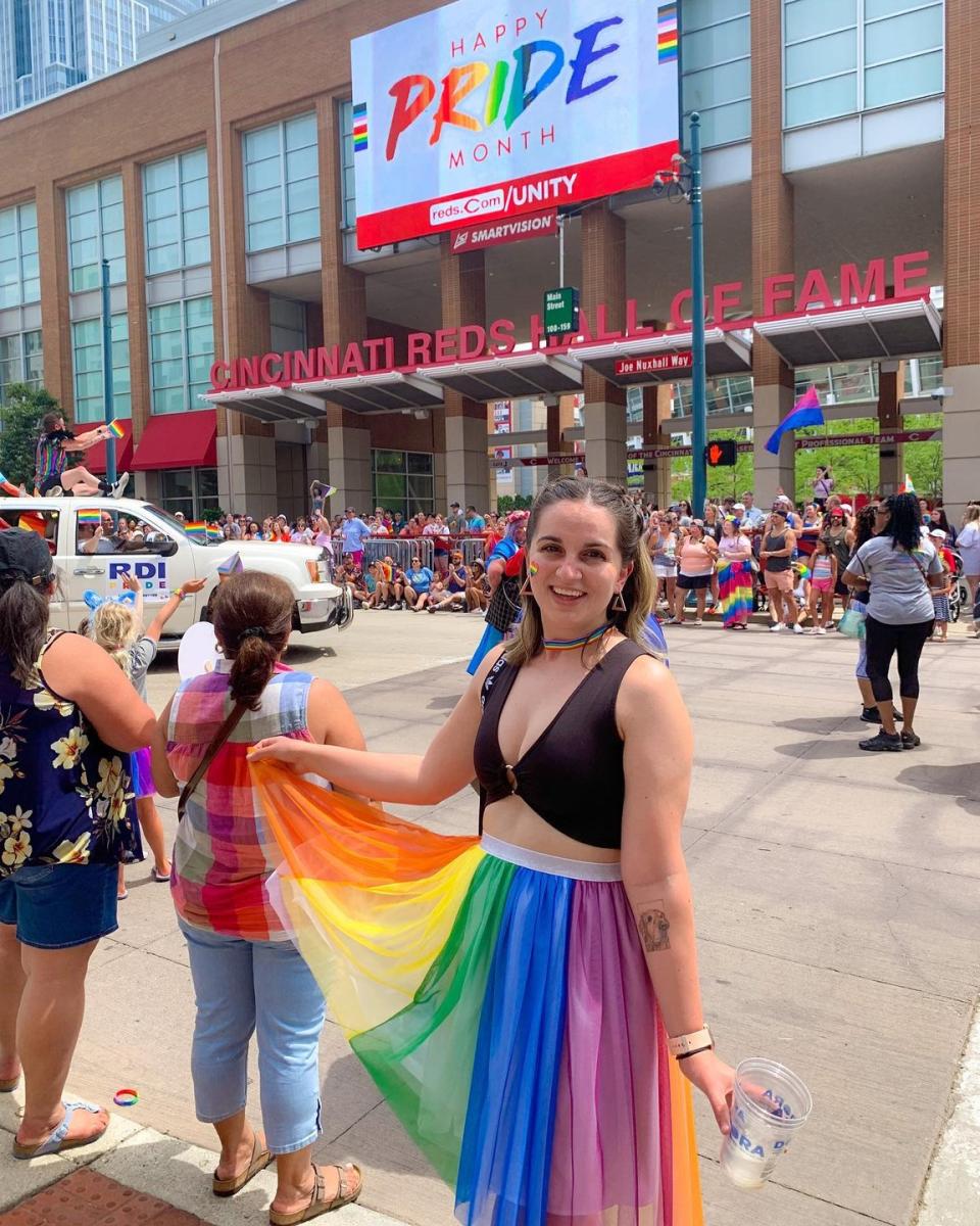 A young woman in a rainbow skirt outside the Great American Ballpark during Cincinnati Pride