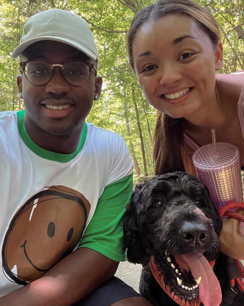 young couple with a dog on a nature trail