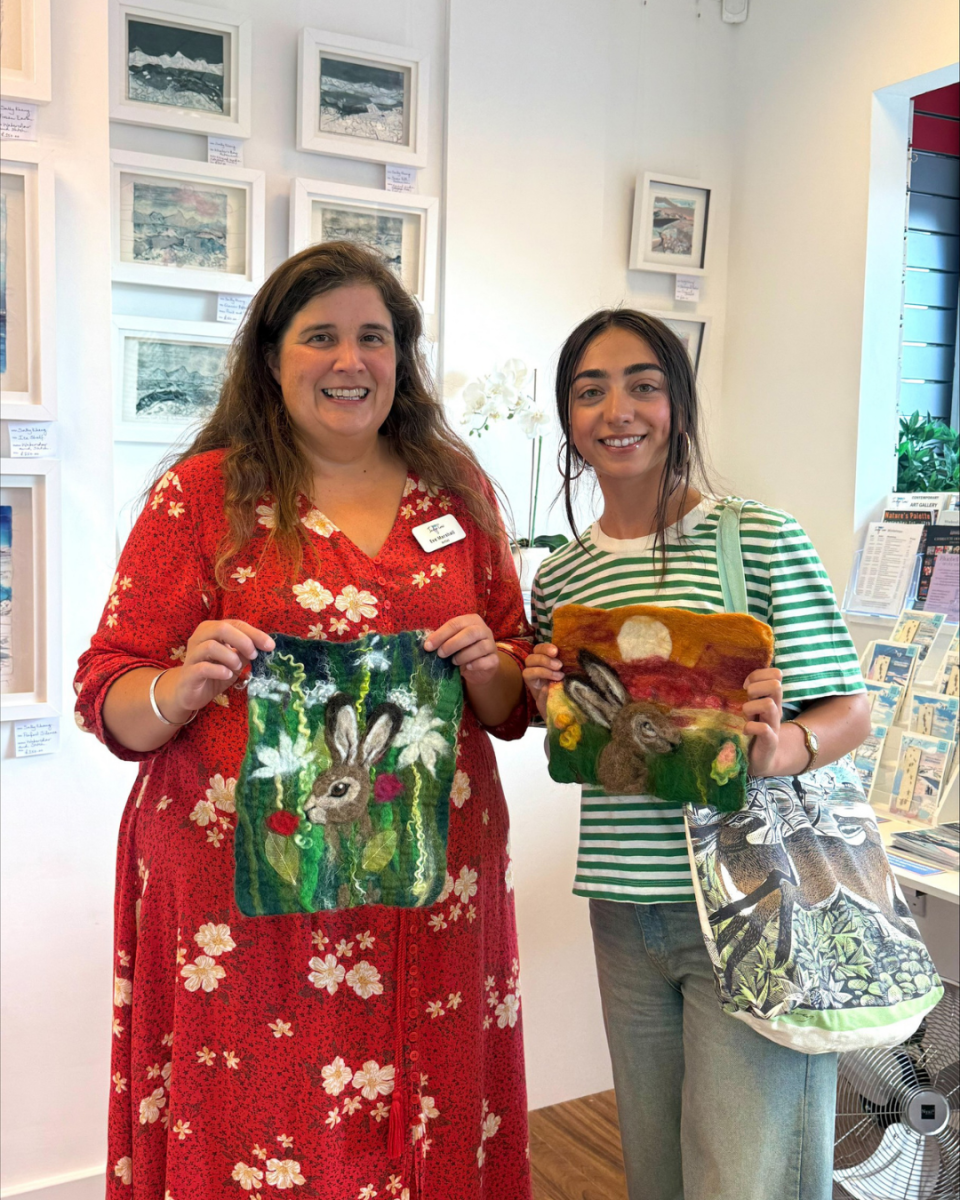 Image shows two people stood at Indigo Crow Gallery.