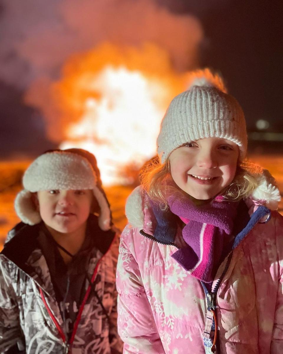Boy and Girl in front of Holiday Tree Bonfire