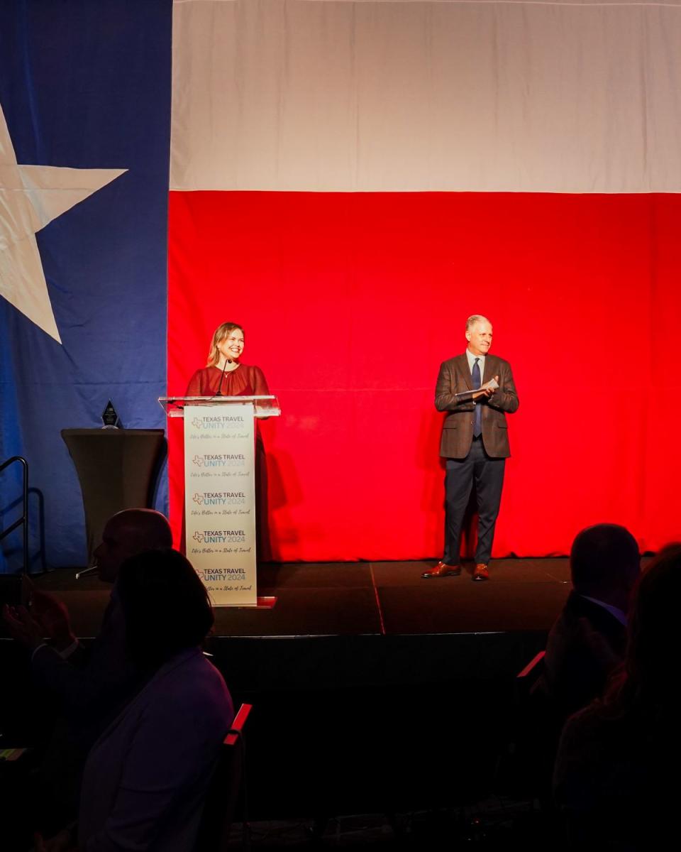Elizabeth Eddins, Executive Director of Visit The Woodlands, and Brad Bailey, Chairman of Visit The Woodlands, Speaking at Unity Dinner in The Woodlands