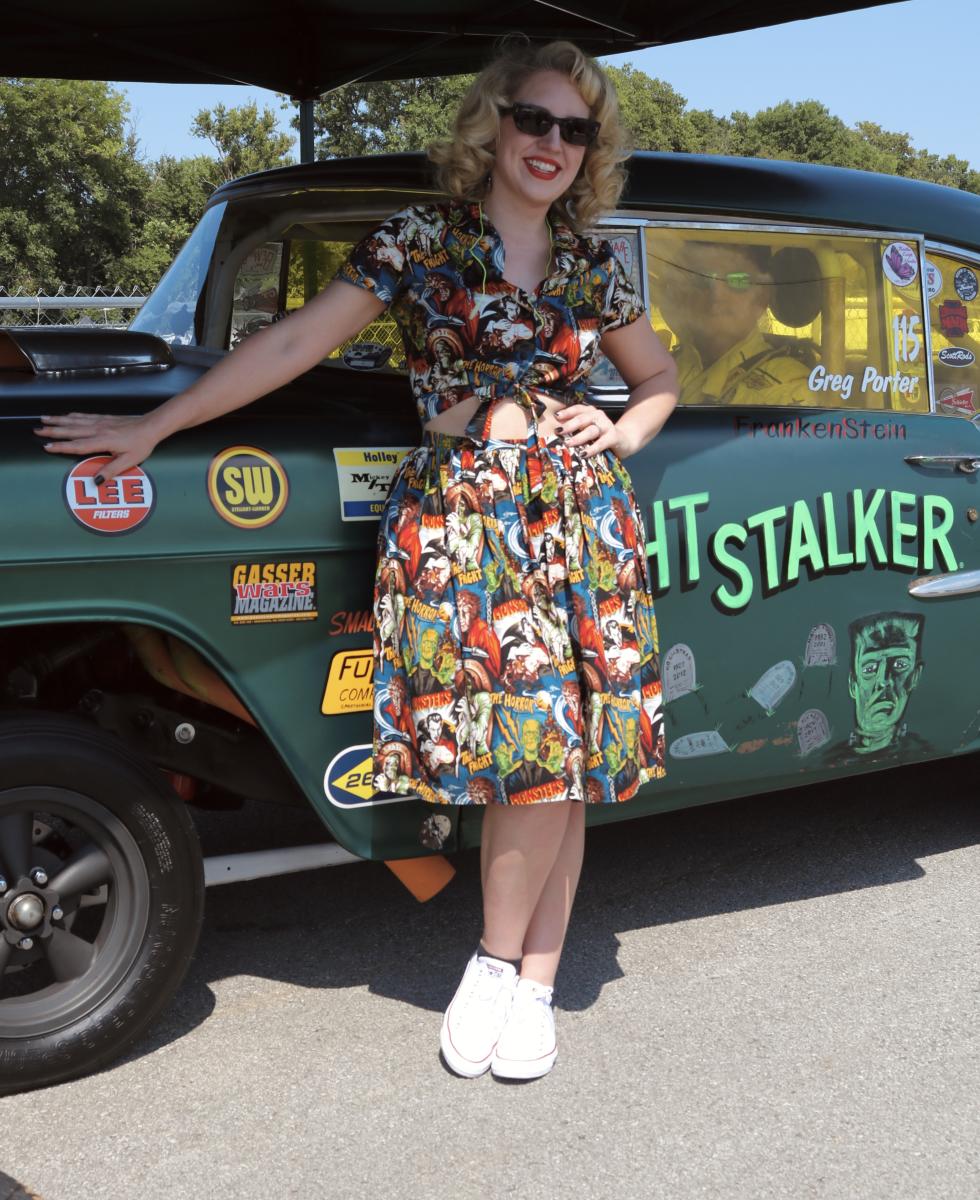 Image of a car with woman posing in front of it at Beech Bend Racway at the Tri-Five Nationals in Bowling Green, Ky.