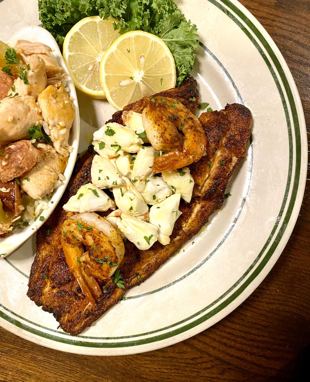 Blackened fish fillet topped with crab meat and shrimp from The Schooner