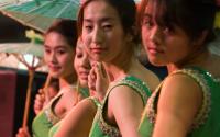 Asian girls performing with umbrellas