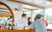 Guests enjoy the bar on the Charles River Cruise
