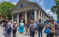 A tour hosted by Boston by Foot makes a stop at Quincy Market