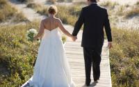 married couple walking on board walk