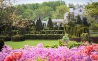 The Main House at Ladew Topiary Gardens with beautiful flowers and topiaries in front of the house