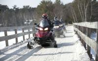 A group heads into the Minocqua wilderness on their snowmobiles.