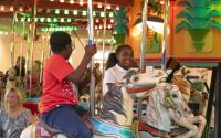 Two children ride the carousel at Botanica Wichita