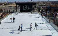 People skate on the ice rink setup at Chicken N Pickle