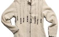 A plush white sweater with black trim and black dots forming lines vertically across the chest.