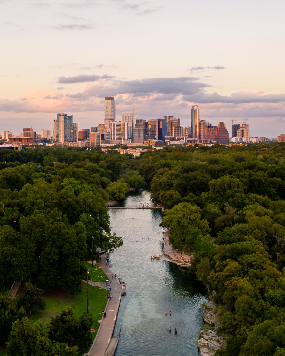 Aerial view of Barton Springs Pool and downtown Austin Texas skyline