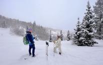 Guide and woman talking on historic snowshoe tour in Park City
