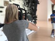 A female camera operator films Antonio and Dianne at Crystal Bridges Museum of American Art.