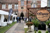 exhibitor marques outside a conference venue with delegates wondering past