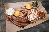 The Bone BBQ platter with meats, beans, coleslaw, corn bread and collard greens