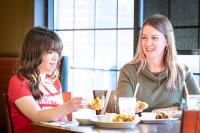 Mother and Daughter enjoying a meal at restaurant
