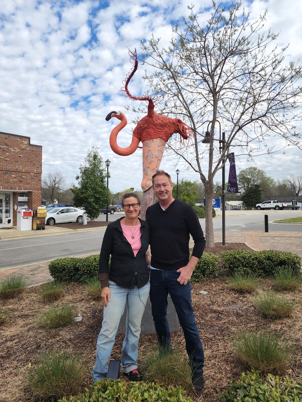 Joni Youngkins-Herzog and Jodi McLeod in front of sculpture on the Clayton Sculpture Trail in Clayton, NC.