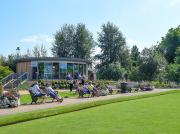 Visitors relaxing outside Albert's Café in Victoria Park, Stafford, on a sunny day.