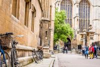 Bicycles near a wall with King's College Chapel in the background