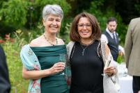 ISTA 2024 Cambridge conference two women smiling towards the camera at an outdoor drinks reception