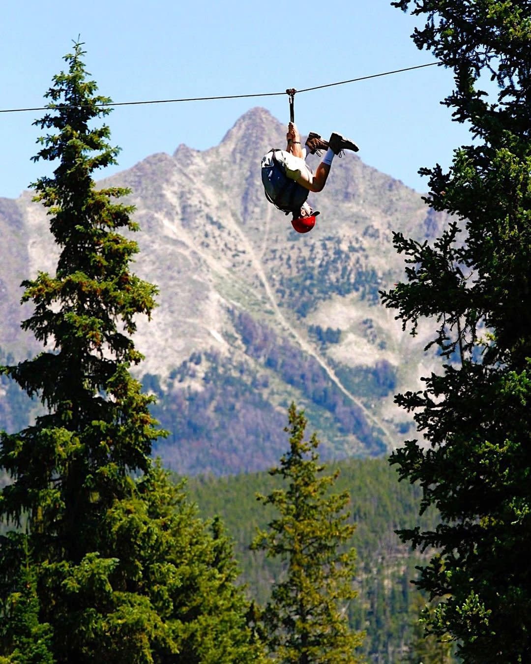 Photo by user whyitsmesky, caption reads Spider-Man tryouts 
#bigskymontana #tbt #zipline #bigskyresort #nature #outdoors