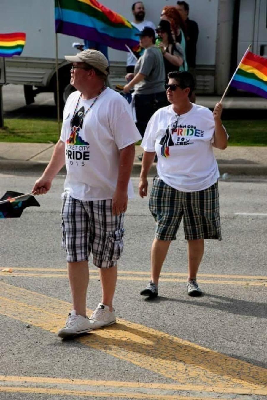 Couple holding Rocket City Pride Flag