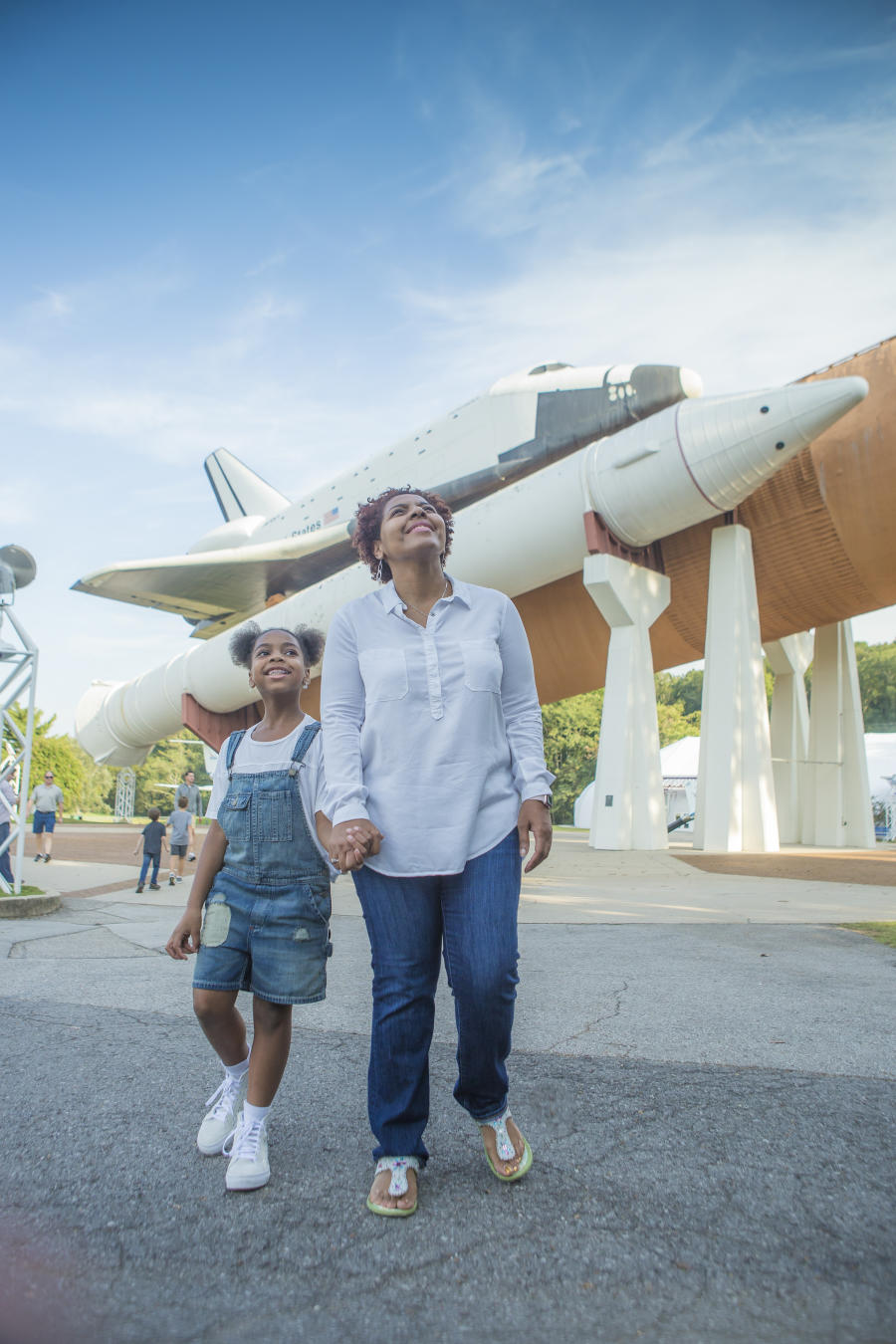 A woman of color and her daughter taking in the US Space and Rocket Center + USSRC