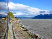Train cars reflect the image of the engine ahead.