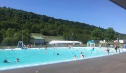 Picture of the McClure Veterans Memorial Pool with the green mountain ridge in the background.
