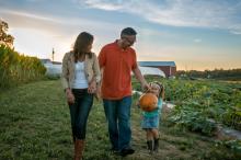 Fall Family picking pumpkins in Strite's Orchard